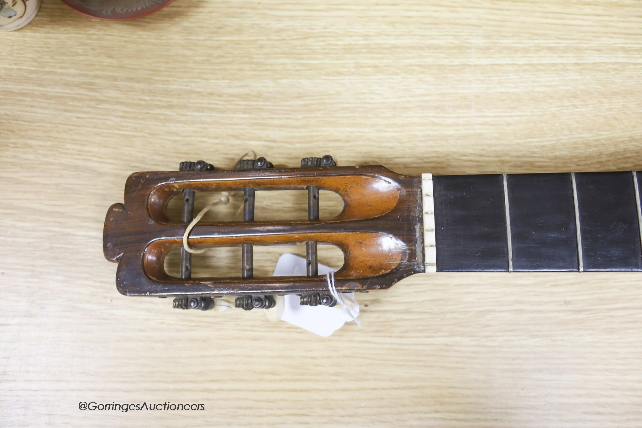 A Mexican mother of pearl inlaid acoustic guitar (no strings)